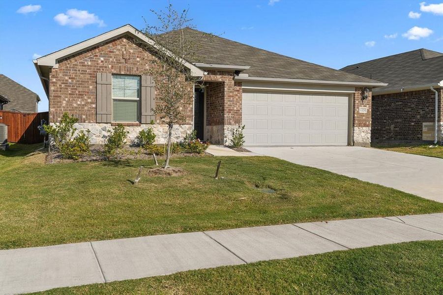 Ranch-style house featuring driveway, a garage, brick siding, stone siding, and a shingled roof Ranch-style house featuring driveway, a garage, brick siding, stone siding, and a shingled roof