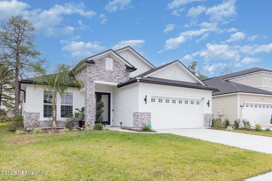 Front exterior of a new home in Hyland Trail, Green Cove Springs, FL, highlighting curb appeal (Image 1). Front exterior of a new home in Hyland Trail, Green Cove Springs, FL, highlighting curb appeal (Image 1).