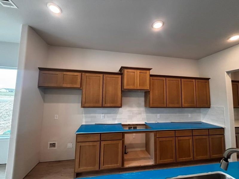 Room with wood-finish flooring, recessed lighting, and a dual-pane window