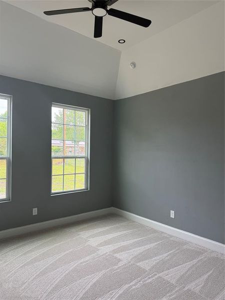 Vaulted ceiling featuring a black ceiling fan with integrated lighting and a recessed light
