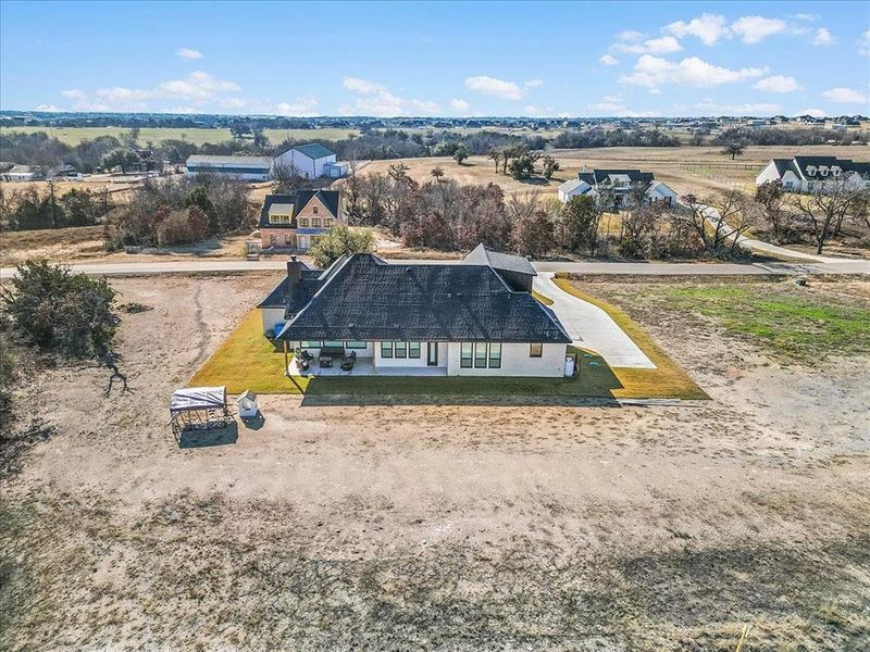 Aerial image facing south overlooking neighbors and the bordering Texas Star Ranch.