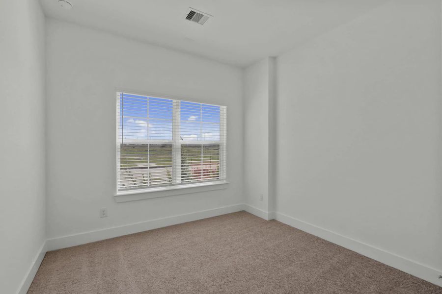 Representative unfurnished interior of a home built from the Chalet by Chesmar Homes in Meridiana Townhomes, Iowa Colony (Image 22).