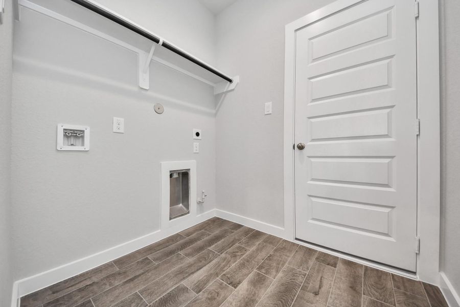 A perfect blend of functionality and comfort. Capture the essence of easy living with a first-floor laundry room, thoughtfully equipped with shelving for effortless organization. Both electric and gas connections available. A perfect blend of functionality and comfort. Capture the essence of easy living with a first-floor laundry room, thoughtfully equipped with shelving for effortless organization. Both electric and gas connections available.