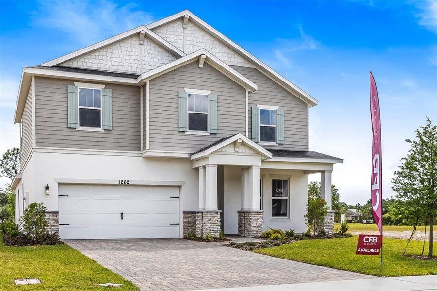 Front exterior of a new home in Gray Hawk at Hole Two, Daytona Beach, FL, highlighting curb appeal (Image 25). Front exterior of a new home in Gray Hawk at Hole Two, Daytona Beach, FL, highlighting curb appeal (Image 25).
