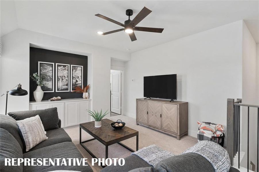 Living room featuring light colored carpet and ceiling fan