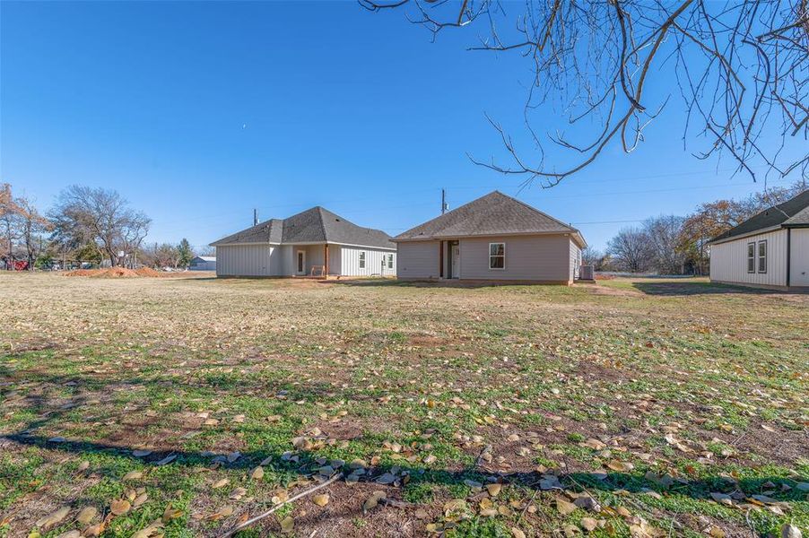 Rear view of property with a yard Rear view of property with a yard