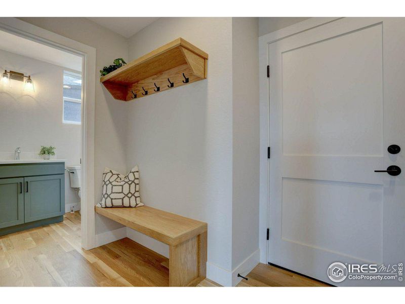 Bench and coat rack off the garage entrance