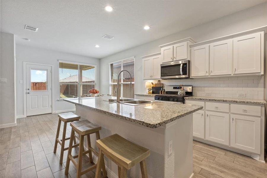 Kitchen featuring stainless steel appliances and granite countertops Kitchen featuring stainless steel appliances and granite countertops