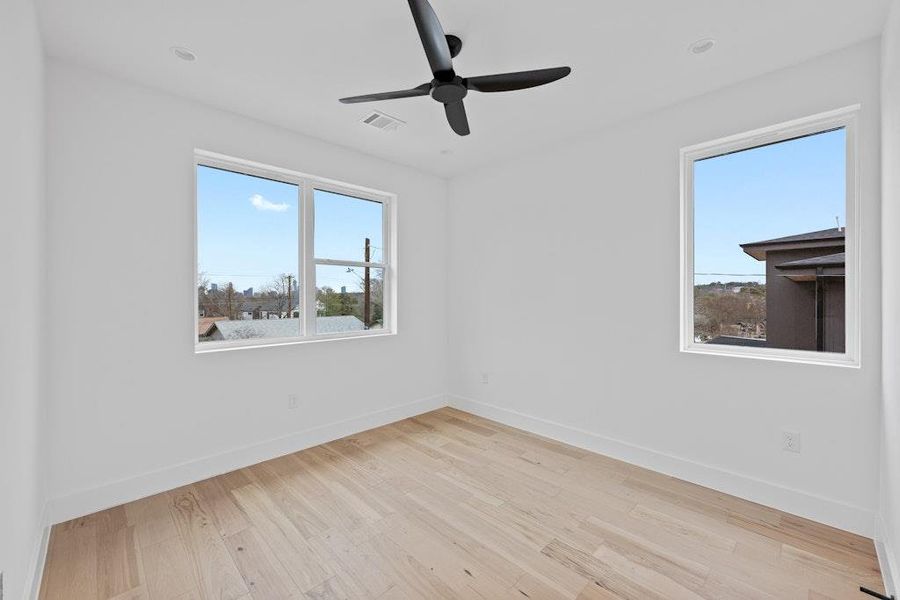Unfurnished room with light wood-style flooring and a ceiling fan