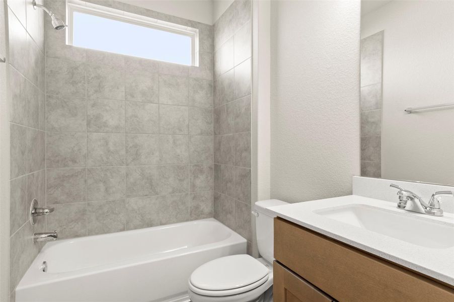 Bathroom with vanity and bathing tub / shower combination