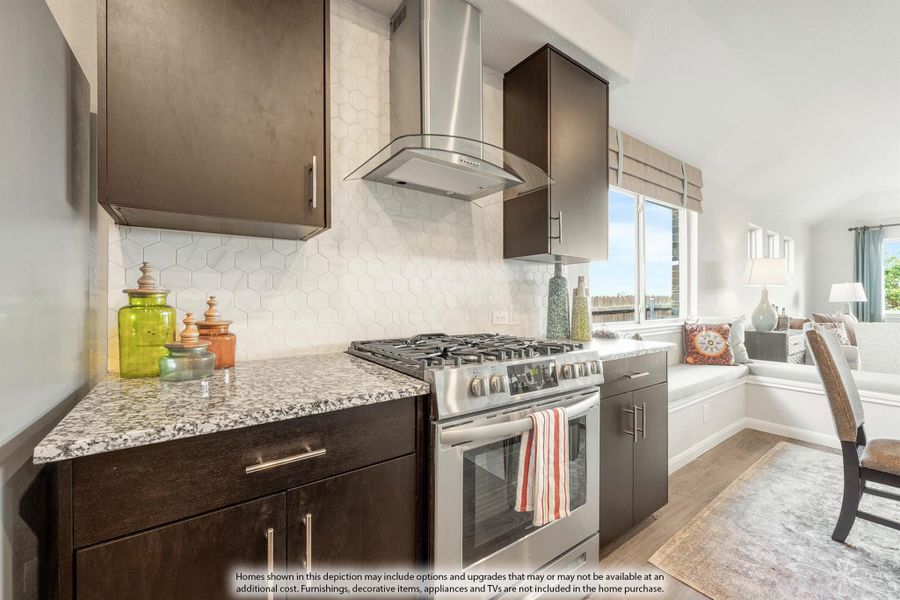 Kitchen with dark cabinets, stainless steel range, hood vent, hexagon tile backsplash, and granite countertops Kitchen with dark cabinets, stainless steel range, hood vent, hexagon tile backsplash, and granite countertops