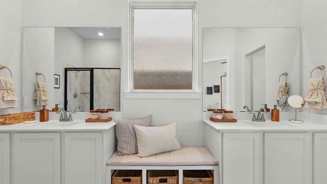 Dual vanities with ample counter space create a functional and appealing primary bathroom. Dual vanities with ample counter space create a functional and appealing primary bathroom.