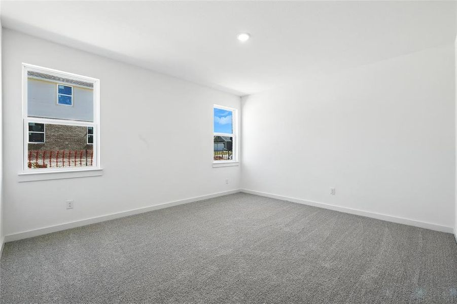 Carpeted empty room featuring baseboards Carpeted empty room featuring baseboards