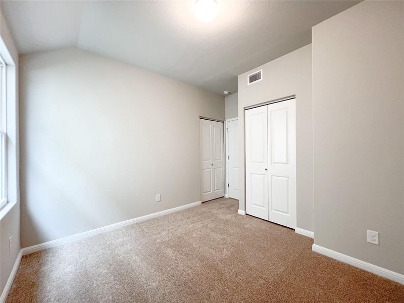 A well-lit chamber featuring plush carpeting and a pair of substantial wardrobes. A well-lit chamber featuring plush carpeting and a pair of substantial wardrobes.