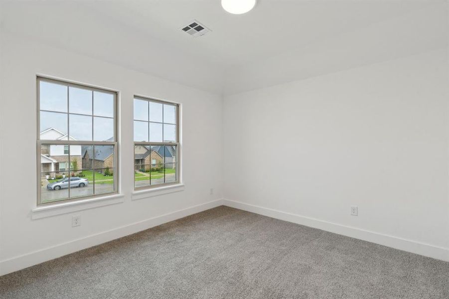 Unfurnished room with carpet and baseboards Unfurnished room with carpet and baseboards