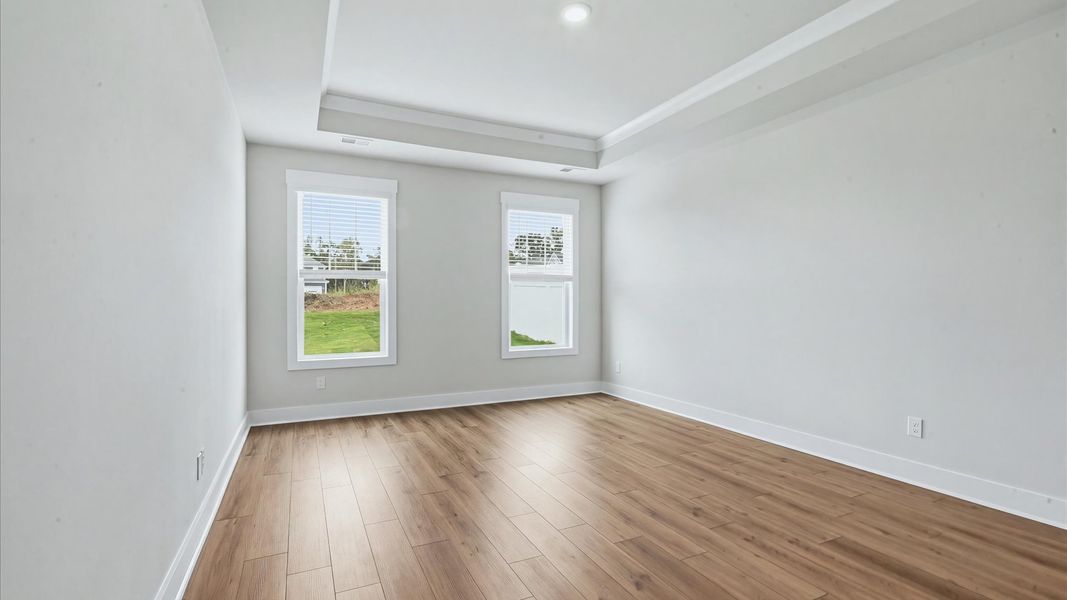 Vibrant natural light fills this exceptional primary suite with eye-catching details located in Spartanburg, SC
