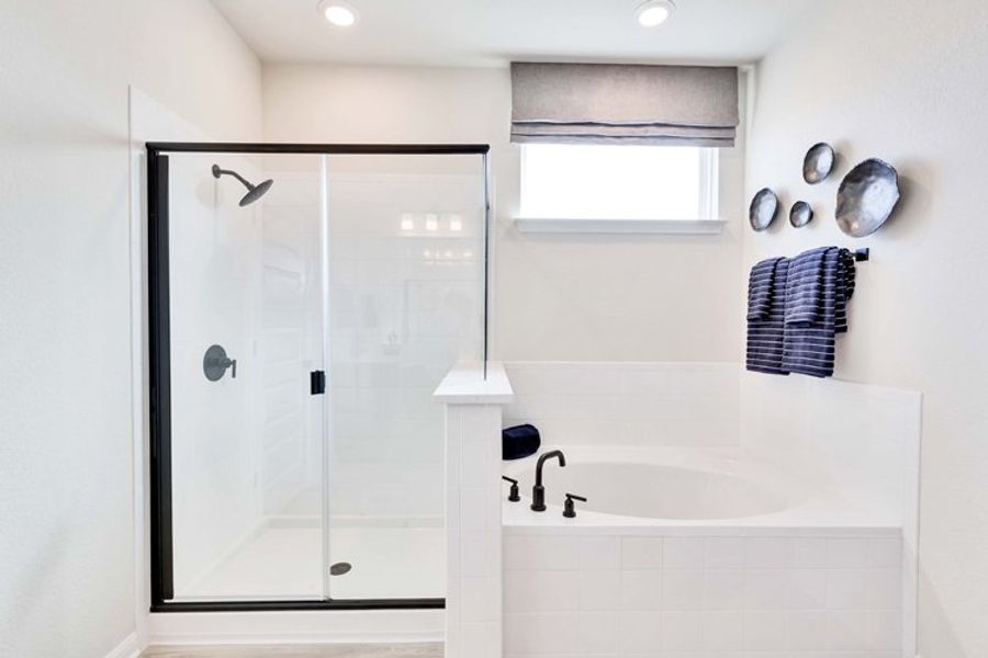 A bathroom with a tub and shower. A bathroom with a tub and shower.