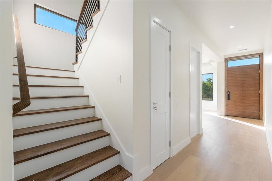 Stairway with wood finished floors and recessed lighting Stairway with wood finished floors and recessed lighting