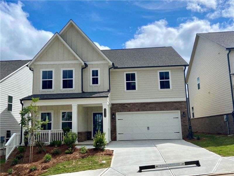 Front exterior of a new home in Eastlyn Crossing, Flowery Branch, GA, highlighting curb appeal (Image 2). Front exterior of a new home in Eastlyn Crossing, Flowery Branch, GA, highlighting curb appeal (Image 2).