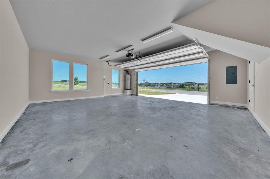 Garage with baseboards and electric panel Garage with baseboards and electric panel