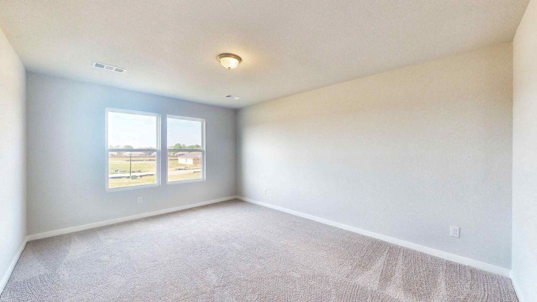 A room with a window and a carpet.