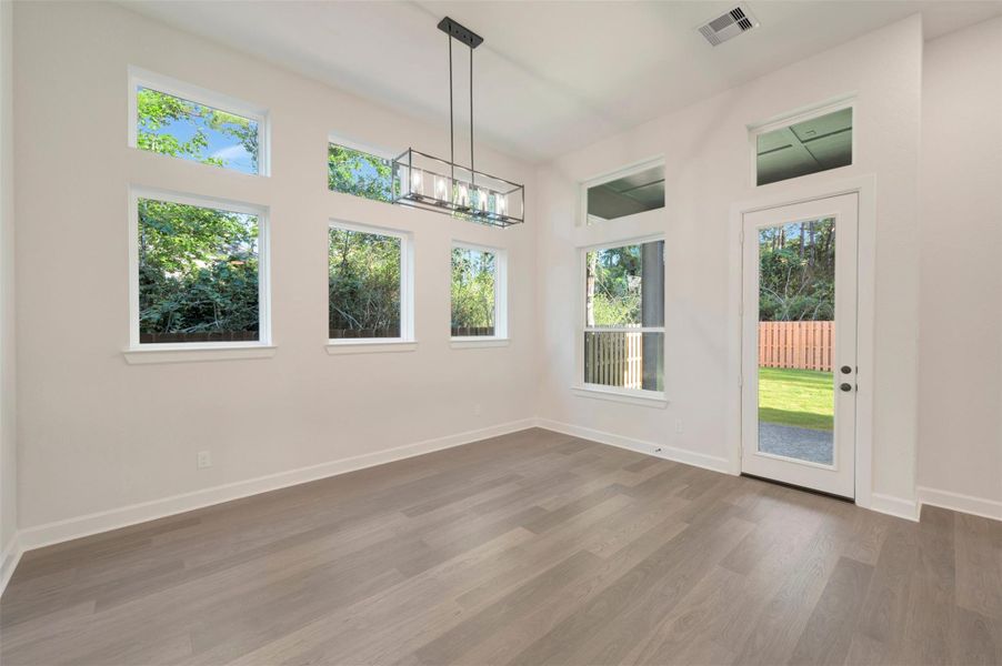 Spacious Dining area with LOTS of windows for light!  Easy access to rear yard as well.