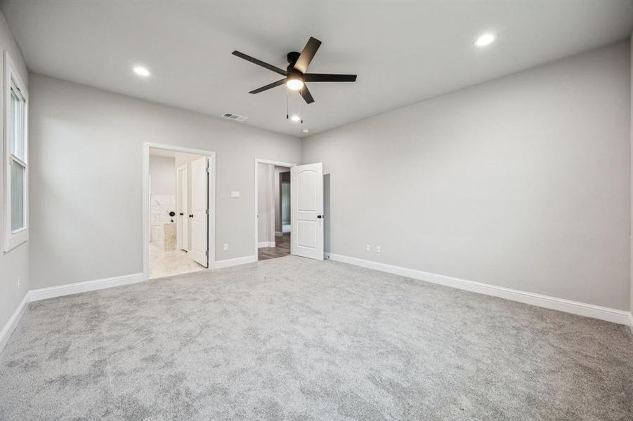 (Bedroom #1) Master Bedroom featuring light carpet, a ceiling fan, recessed lighting, and connected  master bathroom
