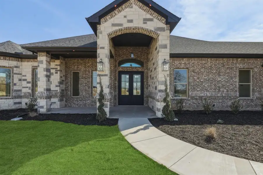 Double iron front door with welcoming front porch. Double iron front door with welcoming front porch.