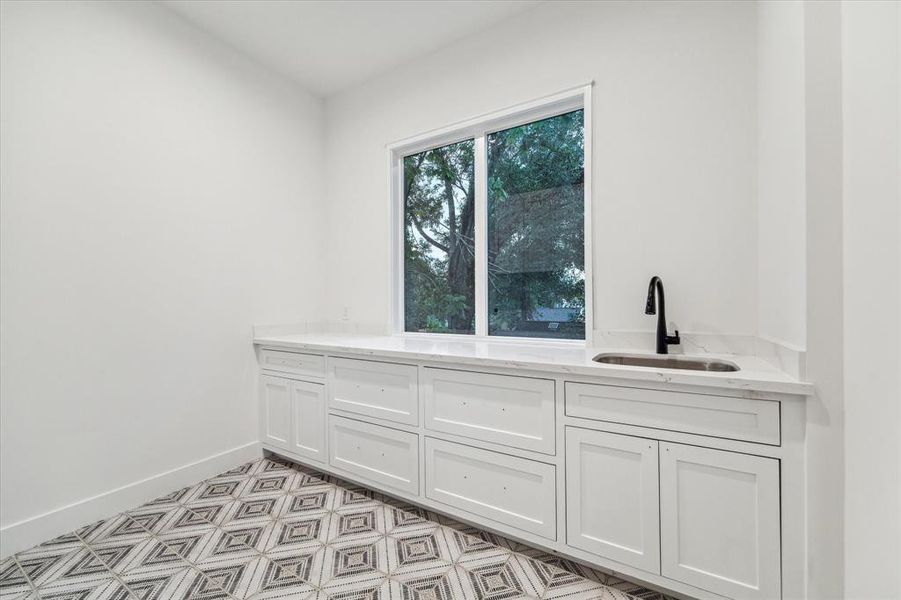 Laundry room complete with sink, centrally located between the upstairs bedrooms