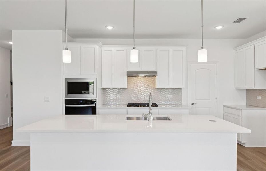 Airy kitchen with oversized island *real home pictured Airy kitchen with oversized island *real home pictured