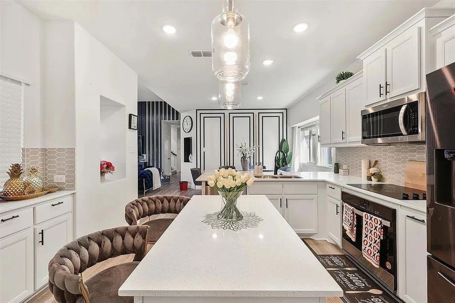 Kitchen featuring a center island, backsplash, stainless steel appliances, and sink