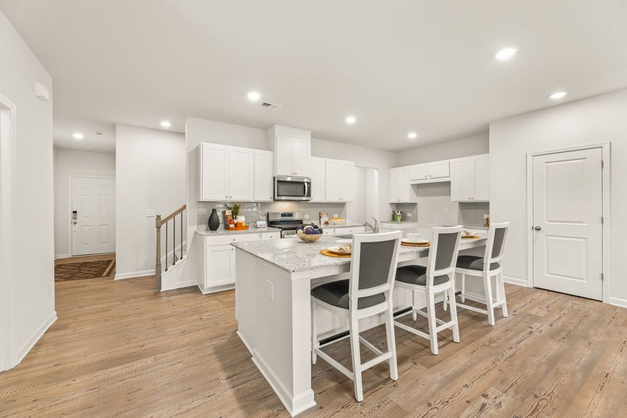 A kitchen with white cabinets.