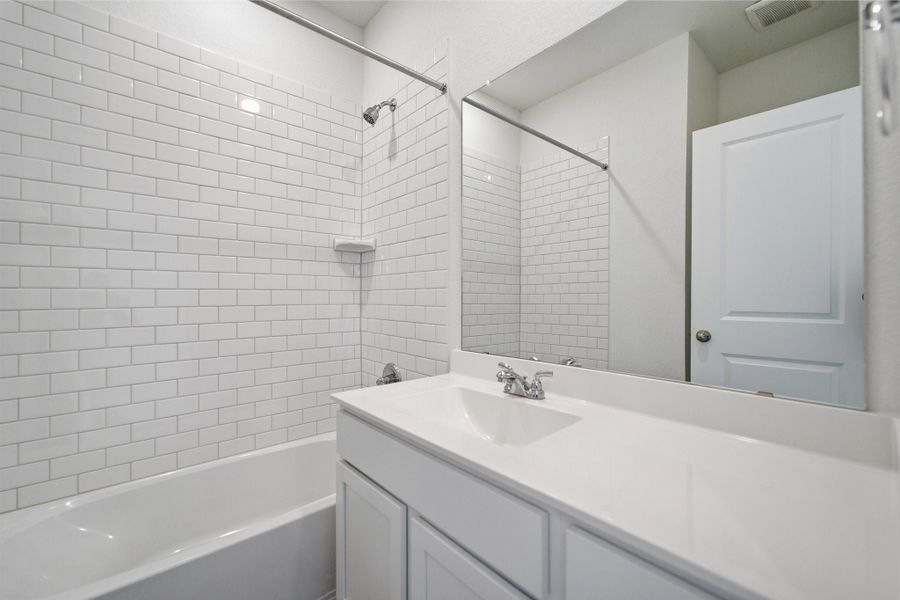 Representative furnished interior of a home built from the Kahn by CastleRock Communities in Municipal Drive Townhomes, Leander (Image 18).