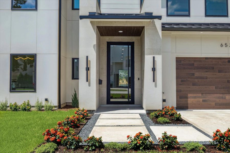 Inviting front walkway with fresh landscaping and bold architectural details. Inviting front walkway with fresh landscaping and bold architectural details.