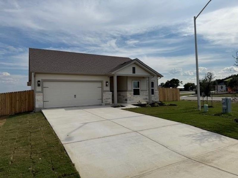 Front exterior of a new home in Grande Estates, Bertram, TX, highlighting curb appeal (Image 14). Front exterior of a new home in Grande Estates, Bertram, TX, highlighting curb appeal (Image 14).