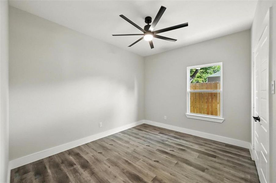 Spare room with wood finished floors and ceiling fan Spare room with wood finished floors and ceiling fan