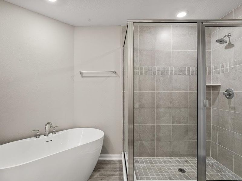 Your spa-like bath features a freestanding tub and a large tiled shower - Donatella bungalow by Highland Homes