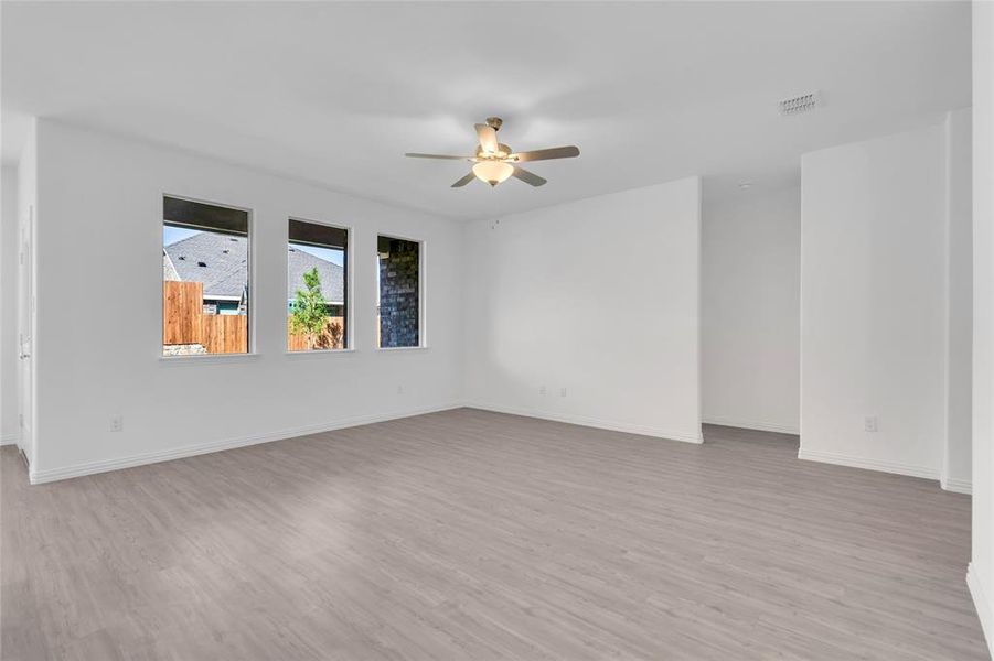 Spare room featuring ceiling fan and light hardwood / wood-style flooring