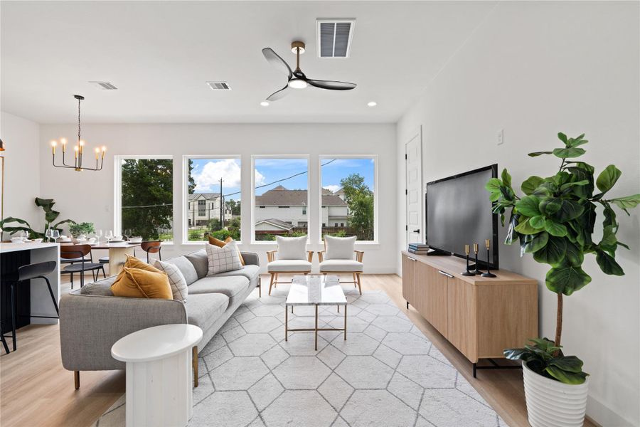 Four oversized picture windowsflood the living space withnatural light, creating an openand airy atmosphere that feelsboth elevated and grounded.