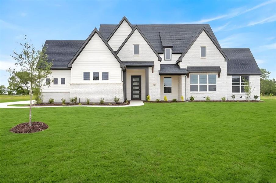Contemporary facade featuring white painted brick, board and batten siding, dark trim accents, and a dark shingle roof Contemporary facade featuring white painted brick, board and batten siding, dark trim accents, and a dark shingle roof