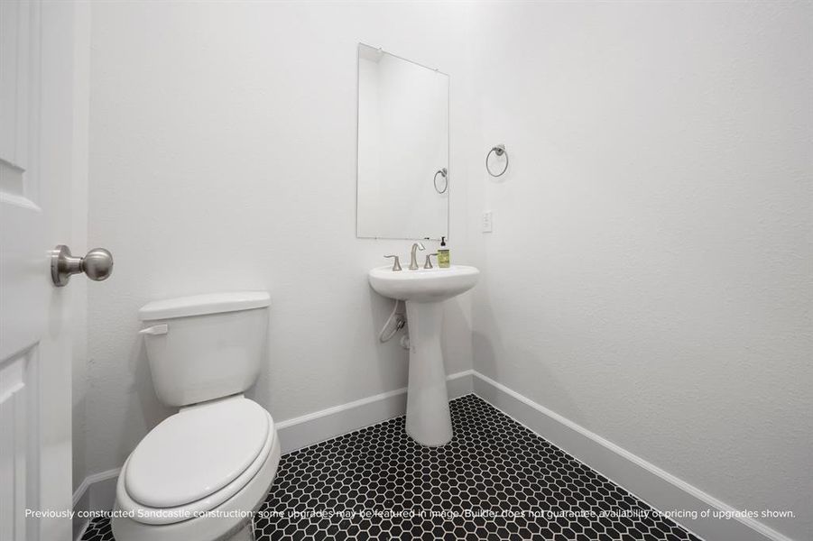 Elegant Powder Room – This half bath features sleek finishes and patterned tile flooring, offering both style and functionality for your guests.