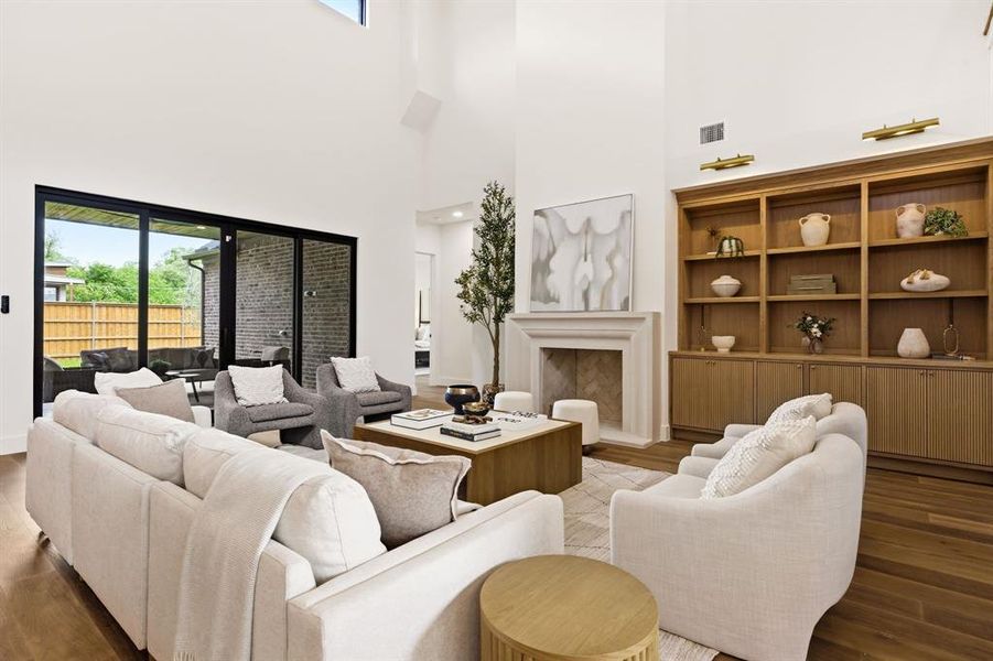 Main living space with 2nd fireplace, built in cabinetry and indoor/outdoor access to patio