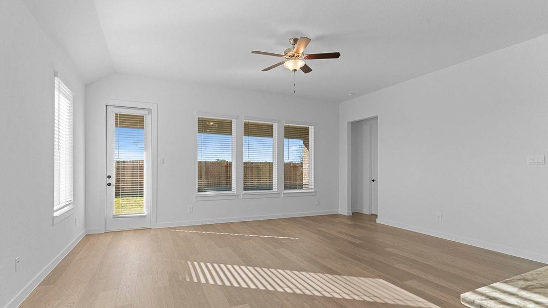 A well-organized living room that includes a kitchen and dining area, creating a warm and welcoming environment for gatherings.
