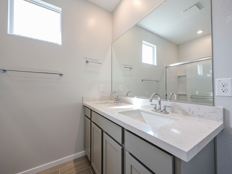 A bathroom with sinks and mirrors.