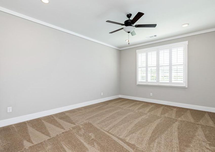 Master bedroom with carpet and a ceiling fan.