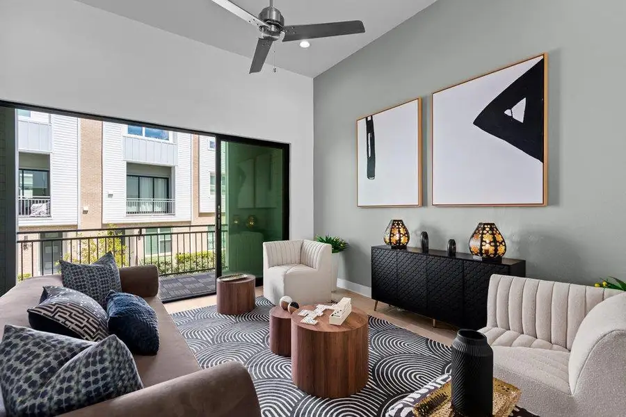 A sliding glass door opens to a private balcony from this airy living space. A sliding glass door opens to a private balcony from this airy living space.