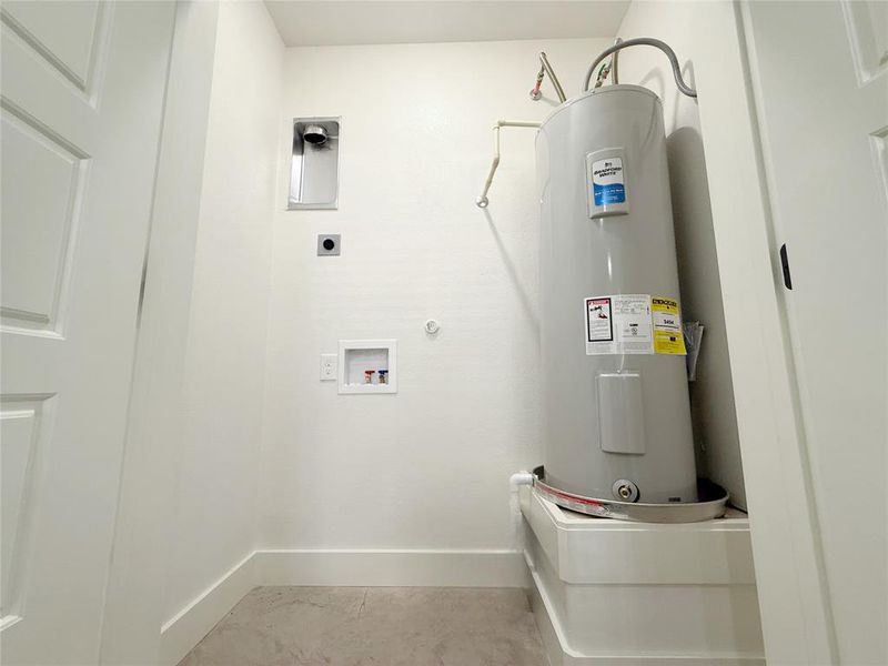 Laundry area featuring laundry area, washer hookup, hookup for an electric dryer, electric water heater, and baseboards Laundry area featuring laundry area, washer hookup, hookup for an electric dryer, electric water heater, and baseboards