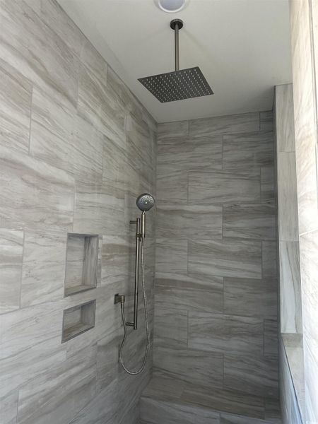 Full bath featuring tiled shower