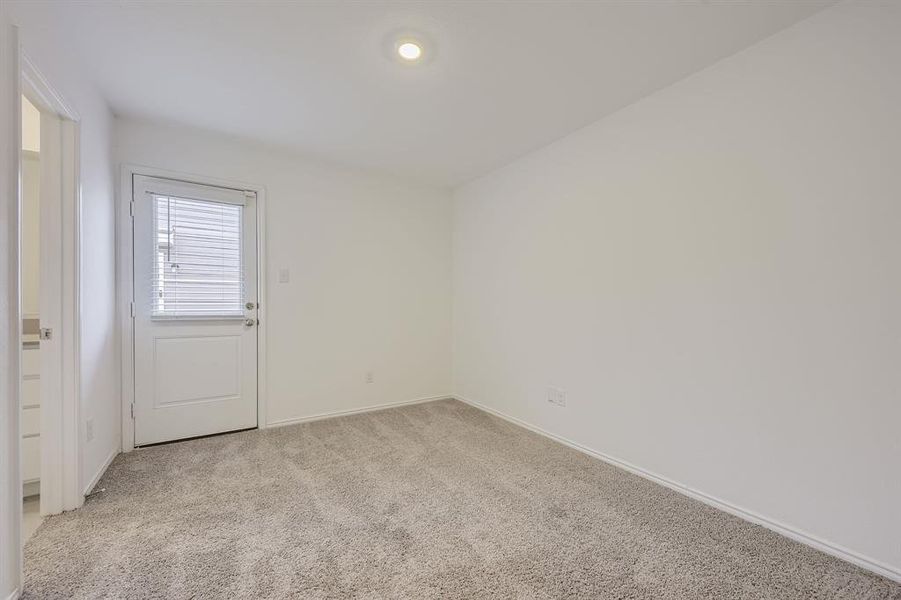 Primary bedroom with plush neutral carpeting and a dedicated full bath