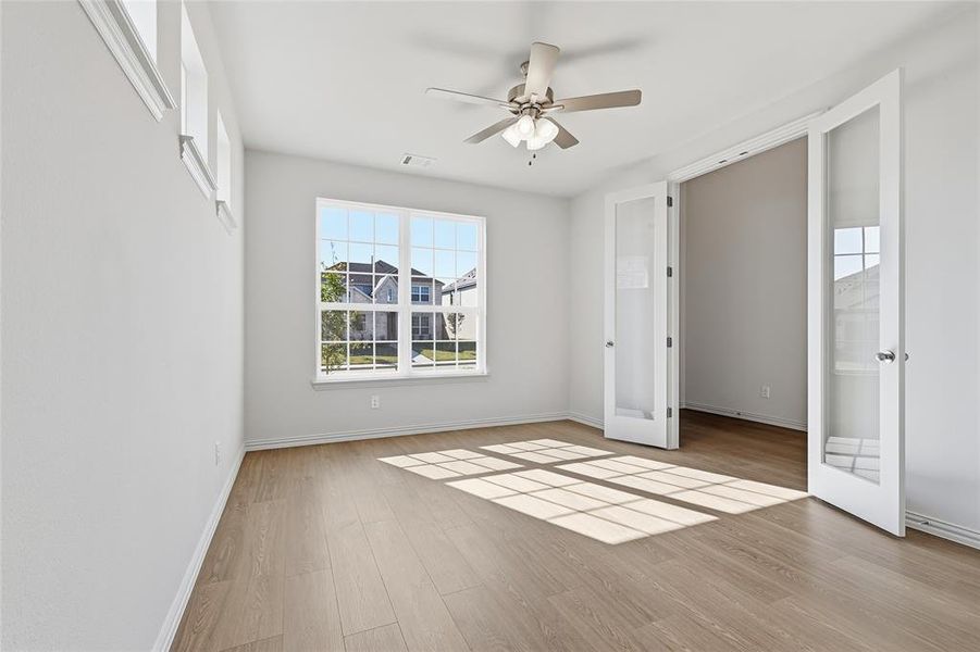 Unfurnished bedroom with light wood-type flooring and a ceiling fan Unfurnished bedroom with light wood-type flooring and a ceiling fan